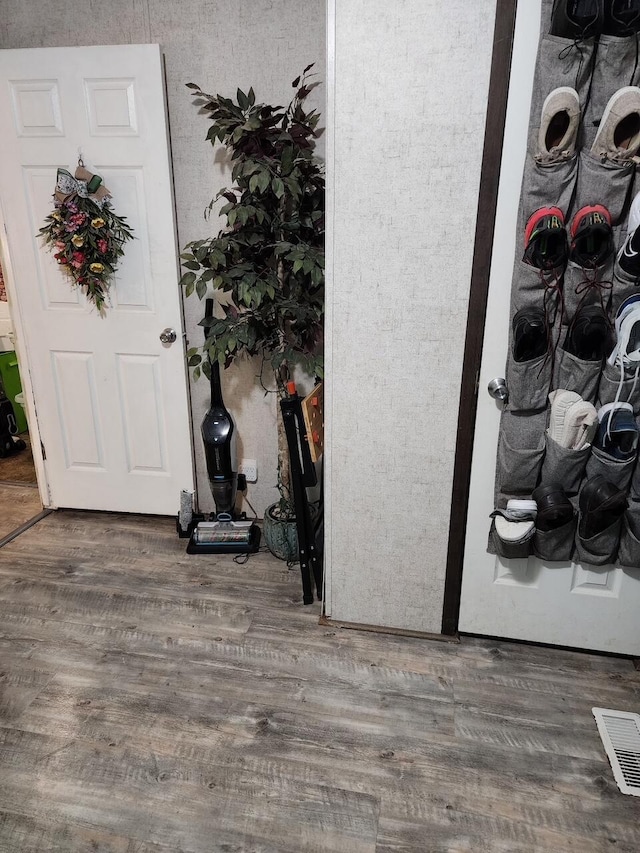 interior space with visible vents and wood finished floors