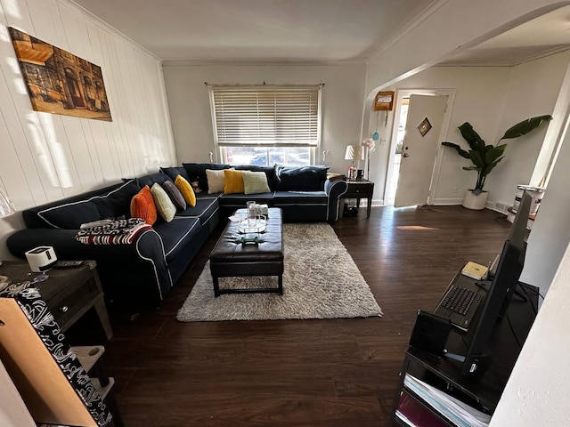 living area featuring wood finished floors, baseboards, and ornamental molding