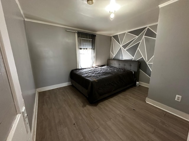 bedroom featuring wood finished floors and baseboards