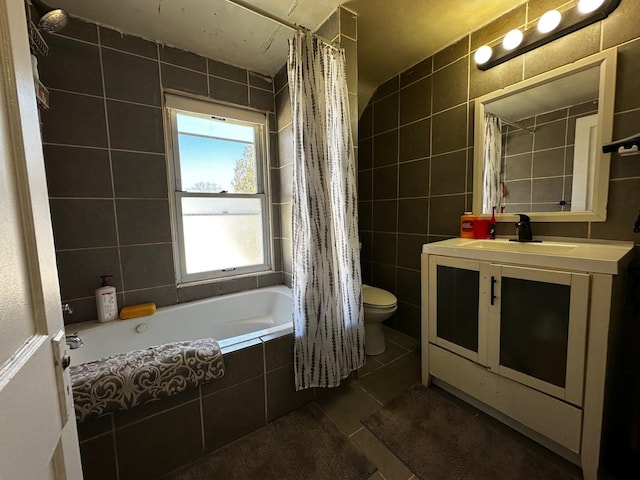 full bath with tile patterned floors, toilet, tile walls, and vanity