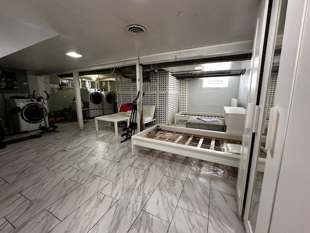 basement featuring washer and dryer, visible vents, and marble finish floor