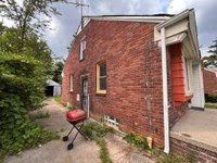 view of side of home featuring brick siding