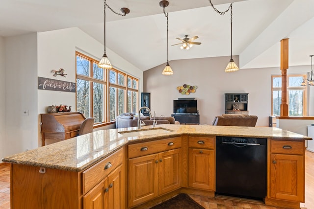 kitchen with light stone countertops, open floor plan, dishwasher, a ceiling fan, and a sink