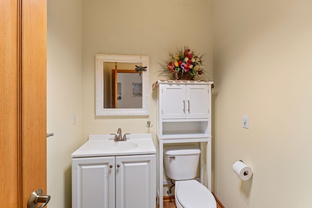 bathroom with toilet and vanity