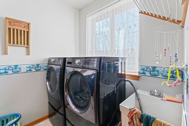 clothes washing area with washing machine and dryer and laundry area