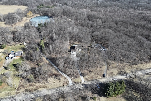 drone / aerial view with a wooded view