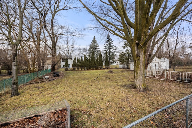 view of yard featuring an outbuilding and a fenced backyard