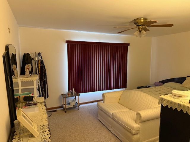 bedroom featuring carpet and a ceiling fan