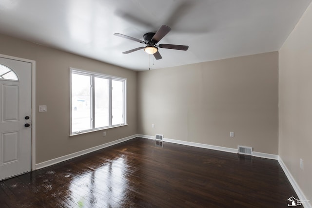 foyer featuring dark wood-style floors, visible vents, and baseboards