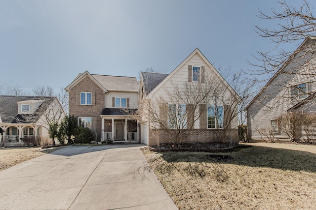 view of front of home with brick siding and concrete driveway