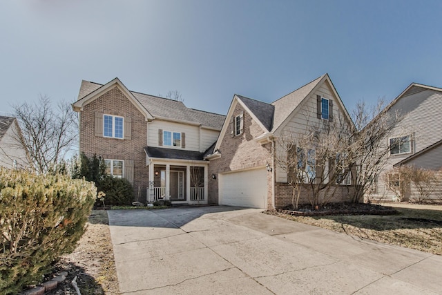 traditional home featuring brick siding, an attached garage, driveway, and a shingled roof