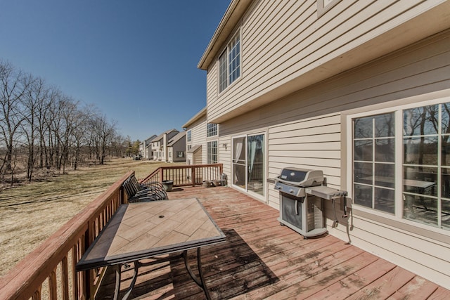 deck featuring grilling area and outdoor dining area