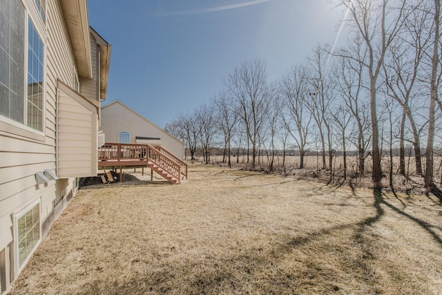 view of yard with a deck and stairs