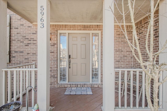 property entrance featuring brick siding