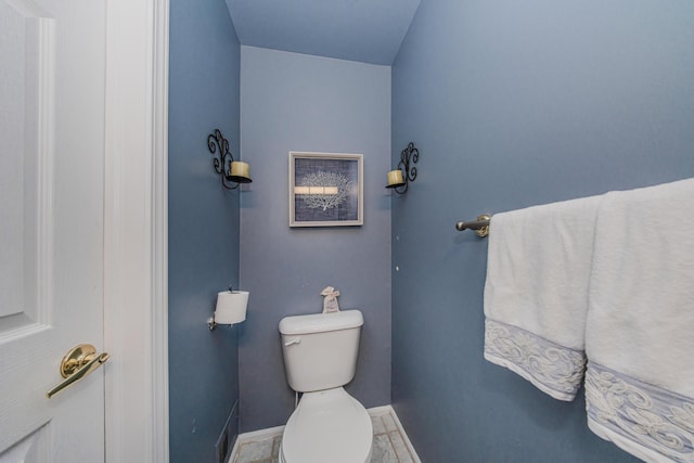 bathroom with baseboards and toilet