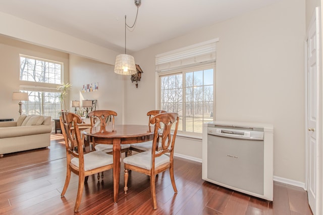 dining area with dark wood finished floors and baseboards