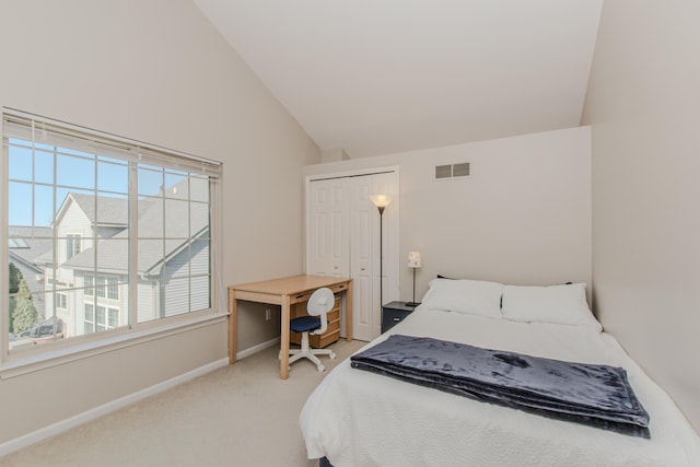 bedroom with baseboards, visible vents, high vaulted ceiling, a closet, and light carpet