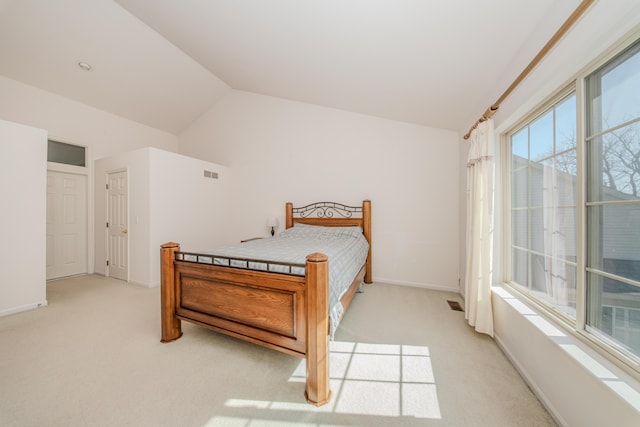 bedroom with visible vents, baseboards, light colored carpet, and vaulted ceiling