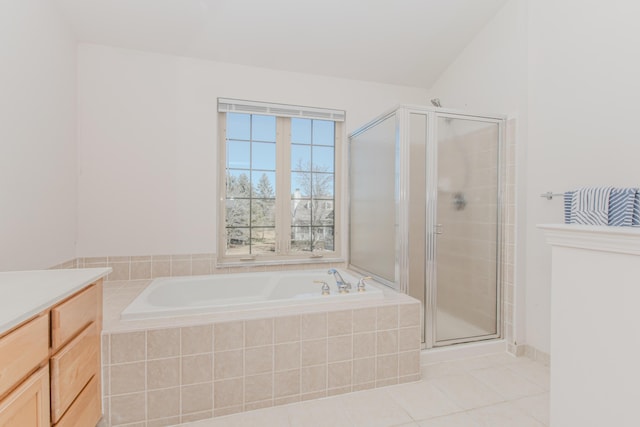 full bathroom with tile patterned flooring, a garden tub, vanity, and a stall shower