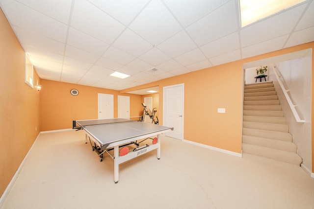 playroom with carpet flooring, a paneled ceiling, and baseboards