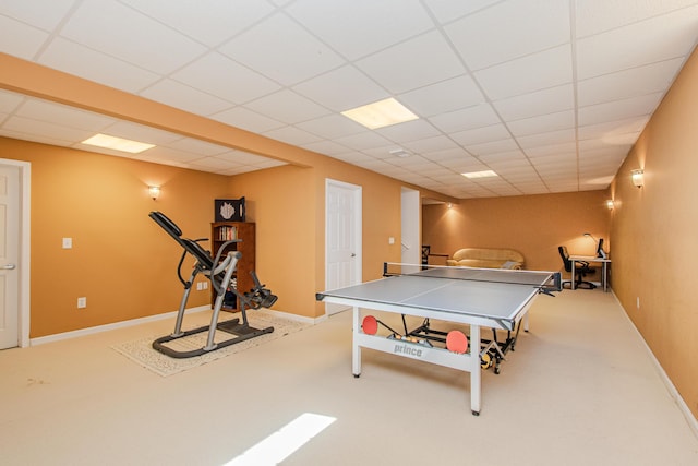 recreation room with a drop ceiling, baseboards, and carpet