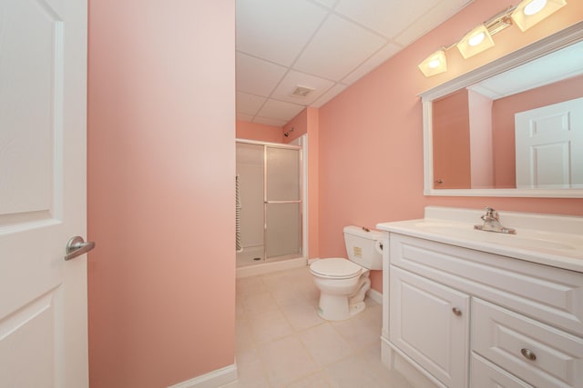 full bath with vanity, a drop ceiling, a shower stall, tile patterned floors, and toilet