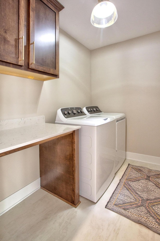 laundry room featuring cabinet space, independent washer and dryer, and baseboards