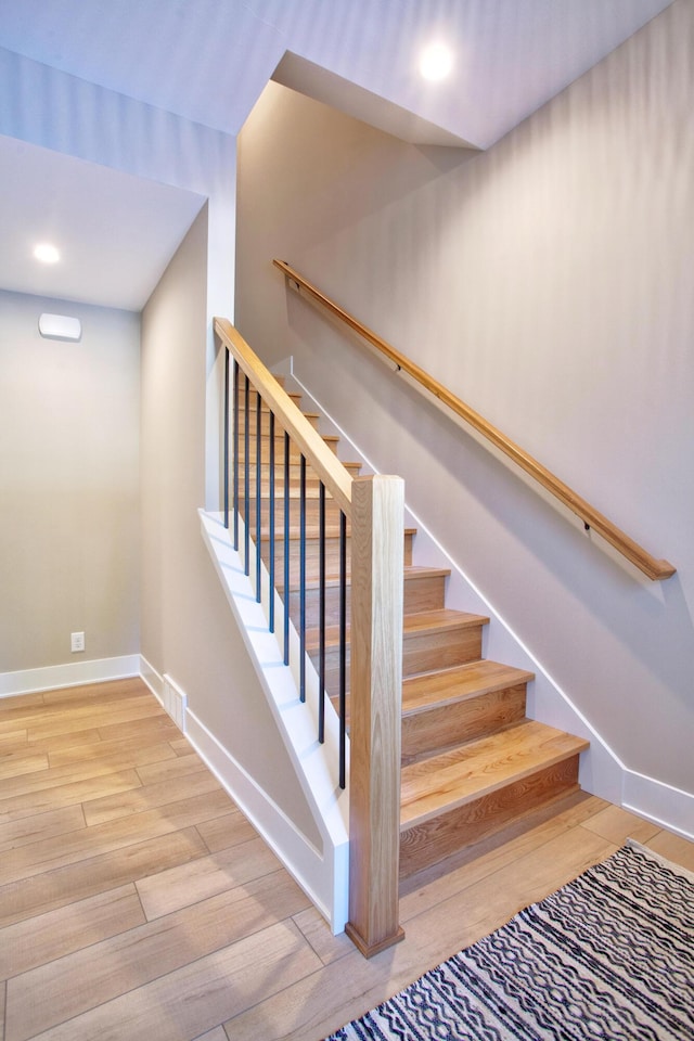 staircase featuring visible vents, recessed lighting, wood finished floors, and baseboards