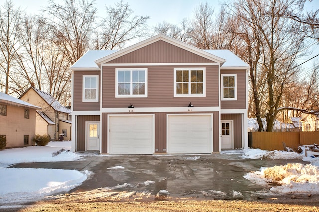 view of front of property featuring a garage and fence