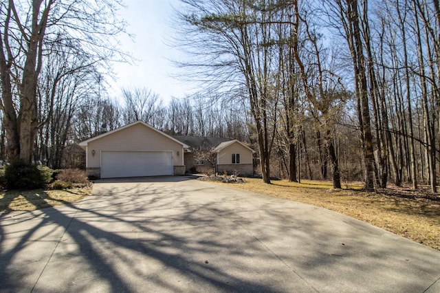 view of front facade featuring brick siding, driveway, and an attached garage