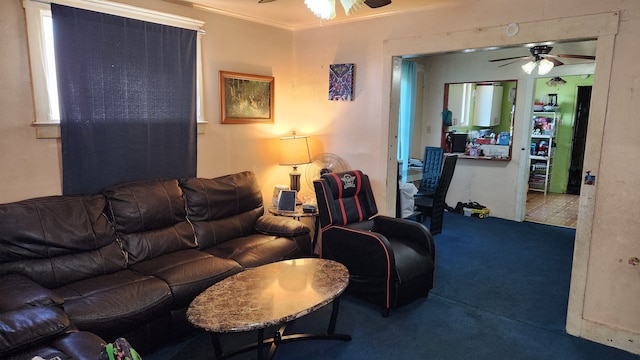 carpeted living room with a ceiling fan and crown molding