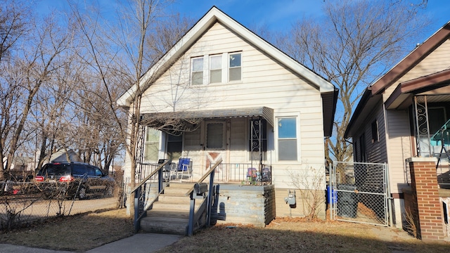 bungalow featuring a gate, fence, and covered porch