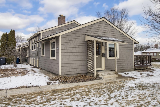 bungalow-style house featuring a chimney