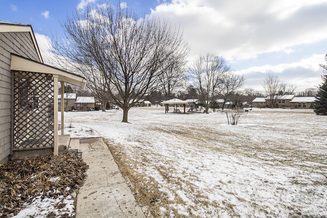 snowy yard with a gazebo