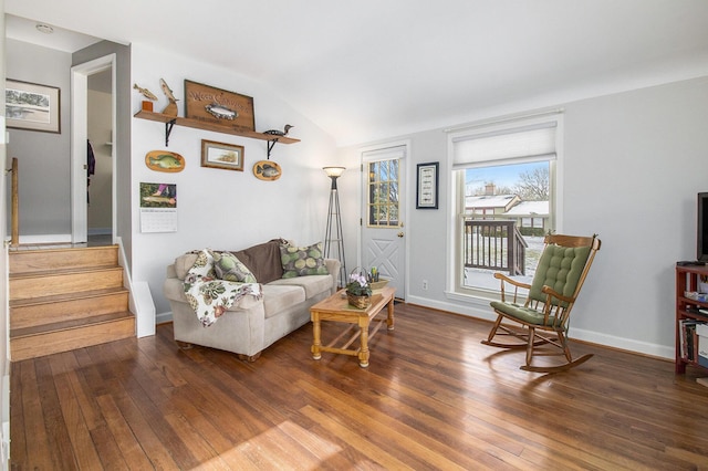 living area with vaulted ceiling, stairway, baseboards, and hardwood / wood-style flooring