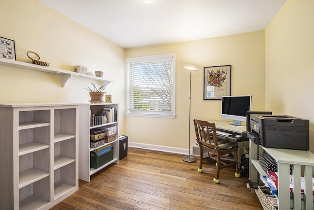 home office featuring baseboards and hardwood / wood-style flooring