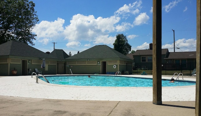 pool featuring a patio area and fence