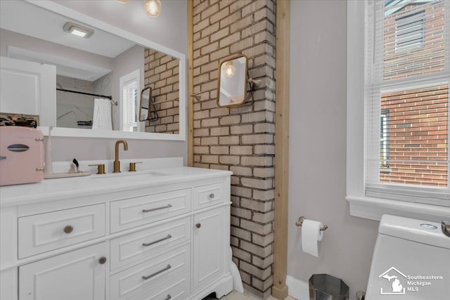 full bath featuring plenty of natural light, brick wall, toilet, and a shower with curtain