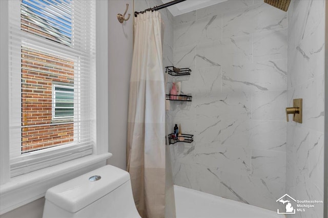 bathroom featuring toilet and a shower with shower curtain