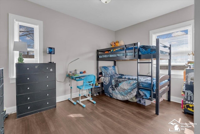 bedroom featuring baseboards and wood finished floors