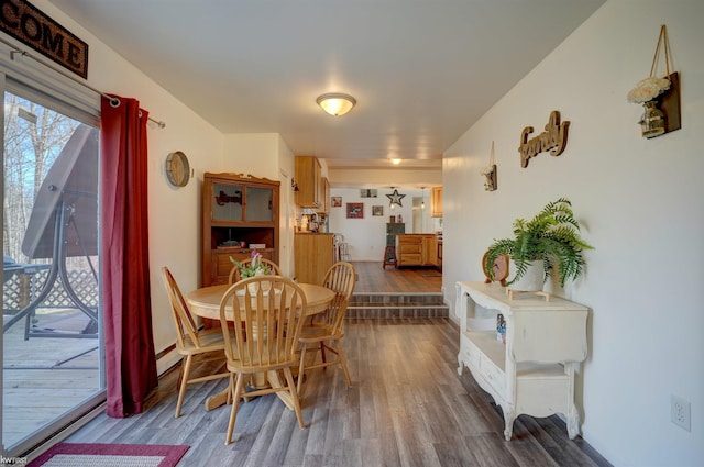 dining room with baseboards and dark wood-style flooring