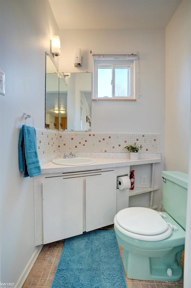 bathroom featuring vanity, tasteful backsplash, tile patterned flooring, and toilet