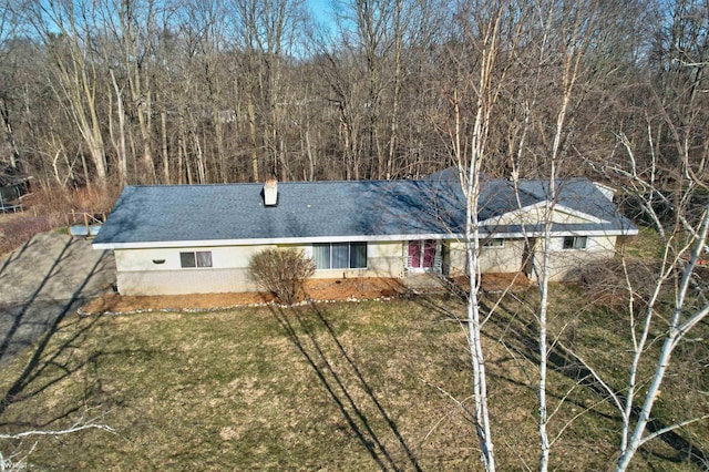 back of house with a lawn