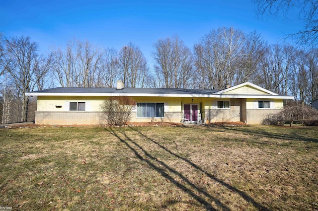 single story home with brick siding, a chimney, and a front lawn