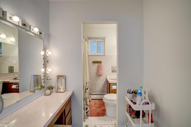 bathroom featuring vanity, tile patterned flooring, tile walls, toilet, and baseboard heating