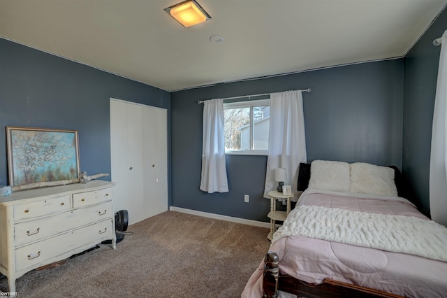 bedroom featuring a closet, baseboards, and carpet