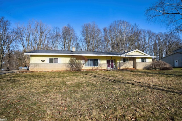 single story home with a front lawn and brick siding