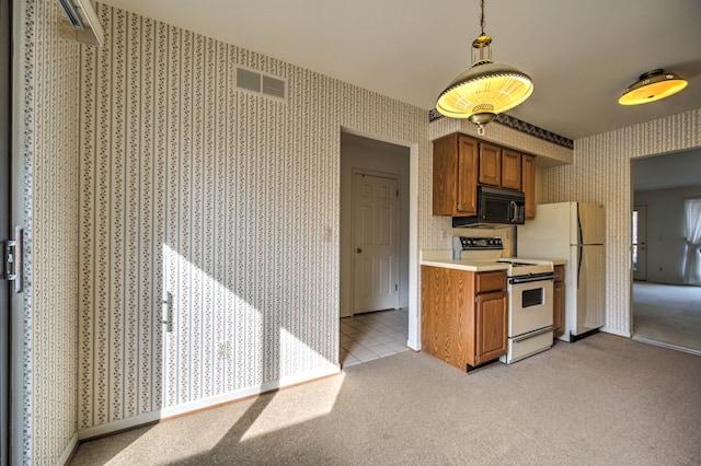 kitchen featuring visible vents, brown cabinets, white appliances, wallpapered walls, and light colored carpet