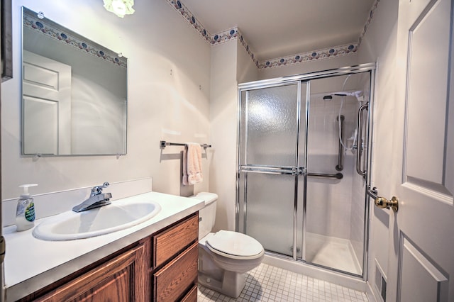 full bath with tile patterned floors, toilet, a stall shower, and vanity