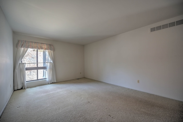 carpeted spare room with visible vents